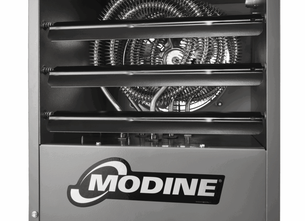 electric unit heater front detail image, model HER, featuring a zoomed in front view, silver and brushed stainless steel Modine logo decal, sleek gray powder coating finish, black directorial louvers, and electric heating element inside of unit