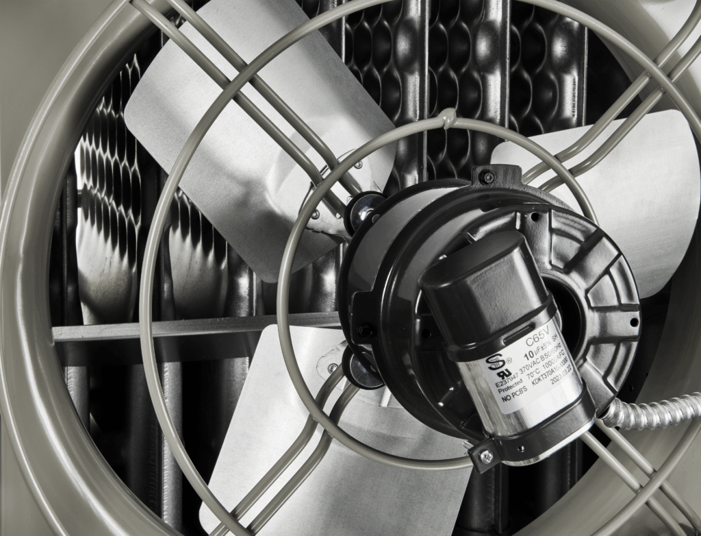 Modine commercial gas-fired power-vented unit heater, model PDP, detail view of the back of unit featuring a magnified view of the propeller fan, fan motor, and the fan cage.